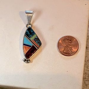 Silver pendant inlaid with various stones